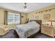 Cozy bedroom with natural light, neutral color scheme, and simple furnishings at 1760 Commonwealth Trl, Cumming, GA 30041