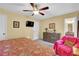 Bedroom featuring a bed with floral comforter, accent chair, and dresser with TV at 1760 Commonwealth Trl, Cumming, GA 30041