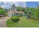 Traditional home featuring an attached garage, lush landscaping, and well-kept lawn at 1760 Commonwealth Trl, Cumming, GA 30041