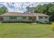 Ranch style home featuring well-maintained lawn and mature landscaping at 1760 Commonwealth Trl, Cumming, GA 30041