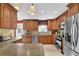 Kitchen features stainless steel appliances and wood cabinetry with granite countertops at 1760 Commonwealth Trl, Cumming, GA 30041