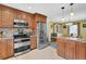 Well-lit kitchen and dining area with stainless appliances and charming cabinetry at 1760 Commonwealth Trl, Cumming, GA 30041