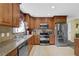 Traditional kitchen featuring stainless steel appliances, tile backsplash and granite countertops at 1760 Commonwealth Trl, Cumming, GA 30041