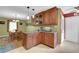 Spacious kitchen with wooden cabinets, granite countertops, and adjacent dining area at 1760 Commonwealth Trl, Cumming, GA 30041