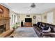 Open concept living room with brick fireplace, hardwood floors, and neutral paint at 1760 Commonwealth Trl, Cumming, GA 30041