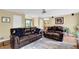 Open-concept living room with hardwood floors, neutral paint, and comfortable furnishings at 1760 Commonwealth Trl, Cumming, GA 30041