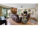 Bright living room with brick fireplace, hardwood floors, and leather furniture at 1760 Commonwealth Trl, Cumming, GA 30041