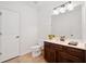 Neutral powder room with a tiled floor and a dark wood vanity at 1045 Westcroft Ln, Roswell, GA 30075