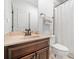 Bathroom featuring vanity with dark wood cabinets, tan countertops, and neutral walls at 1045 Westcroft Ln, Roswell, GA 30075