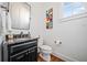 Elegant powder room featuring a sleek vanity with granite countertop and modern fixtures at 1045 Westcroft Ln, Roswell, GA 30075