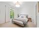 Serene bedroom with a window, neutral palette, carpet, and stylish furnishings at 1045 Westcroft Ln, Roswell, GA 30075