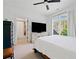 Well-lit bedroom with ensuite bath featuring a television, bright window, carpet, and furnishings at 1045 Westcroft Ln, Roswell, GA 30075