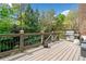 Spacious outdoor deck with built in lights, grill, and wooded views at 1045 Westcroft Ln, Roswell, GA 30075