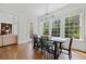 Bright dining room features hardwood floors, modern lighting and natural light from the large windows at 1045 Westcroft Ln, Roswell, GA 30075