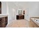 Bright main bathroom with granite countertops, a soaking tub, and natural light streaming through the large windows at 1045 Westcroft Ln, Roswell, GA 30075