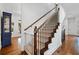 Staircase with dark wood and black iron railings adding a touch of elegance to the entryway of the home at 1045 Westcroft Ln, Roswell, GA 30075
