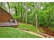 Landscaped backyard, perfect for entertaining, features a stone patio and a lush grassy area surrounded by mature trees at 1250 Northcliff Trce, Roswell, GA 30076