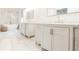 Bathroom featuring double sink vanity with marble countertop, bathtub, and marble tile flooring at 1250 Northcliff Trce, Roswell, GA 30076