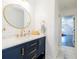 This bathroom features a vanity with gold fixtures and a round mirror at 1250 Northcliff Trce, Roswell, GA 30076