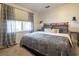 Cozy bedroom featuring natural light, plush bedding and stylish wall sconces at 1250 Northcliff Trce, Roswell, GA 30076