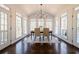 Sunroom dining area with vaulted ceilings, lots of windows, and hardwood floors at 1250 Northcliff Trce, Roswell, GA 30076