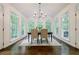 Bright dining room with hardwood floors, chandelier, and large windows overlooking the backyard at 1250 Northcliff Trce, Roswell, GA 30076