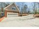 Attached garage with brick veneer and ample driveway space, surrounded by lush trees at 1250 Northcliff Trce, Roswell, GA 30076