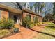 A beautiful brick home with well-manicured landscaping and a brick walkway leading to the entrance at 1250 Northcliff Trce, Roswell, GA 30076