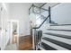Bright foyer with two-story ceilings, hardwood floors, and staircase with black and white risers at 1250 Northcliff Trce, Roswell, GA 30076