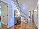 Foyer with hardwood floors, a staircase, and a vintage cabinet with a mirror at 1250 Northcliff Trce, Roswell, GA 30076