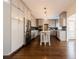 Open kitchen featuring stainless steel appliances, dark hardwood floors, and large kitchen island at 1250 Northcliff Trce, Roswell, GA 30076