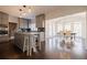 Open kitchen and dining area with an island, stainless steel appliances, and large windows for natural light at 1250 Northcliff Trce, Roswell, GA 30076