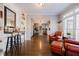 Open living area with hardwood floors, bar area, built-in shelves, and a glimpse of the kitchen at 1250 Northcliff Trce, Roswell, GA 30076