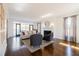 Bright living room with fireplace, hardwood floors, and access to a covered porch at 1250 Northcliff Trce, Roswell, GA 30076