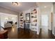 Open living room with hardwood floors, built-in shelves, and an elegant fireplace at 1250 Northcliff Trce, Roswell, GA 30076