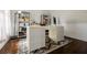 Home office with hardwood floors, built-in shelves, large desk, and natural light at 1250 Northcliff Trce, Roswell, GA 30076