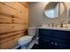 Powder room with a unique wood wall and vanity with a marble countertop at 1250 Northcliff Trce, Roswell, GA 30076