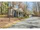 Charming exterior view of the home with a stone wall and landscaped front yard at 1250 Northcliff Trce, Roswell, GA 30076