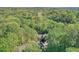 Stunning aerial view of a wooded property with a glimpse of a golf course in the background at 2120 River Heights Se Walk, Marietta, GA 30067