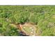 Scenic aerial view of the community golf course, surrounded by lush green trees and a flowing stream at 2120 River Heights Se Walk, Marietta, GA 30067