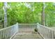 This patio area has a stone floor, white privacy fencing, and serene views of nature at 2120 River Heights Se Walk, Marietta, GA 30067