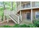 Exterior view of the entry of units 2120, 2122, and 2124, with white stairs and green foliage at 2120 River Heights Se Walk, Marietta, GA 30067