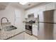Updated kitchen featuring stainless steel appliances, granite counters, and white cabinetry at 2120 River Heights Se Walk, Marietta, GA 30067