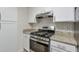 Stainless steel gas range with a subway tile backsplash and granite counters at 2120 River Heights Se Walk, Marietta, GA 30067