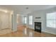 Bright living room with hardwood floors, fireplace with black tile hearth, and a white front door at 2120 River Heights Se Walk, Marietta, GA 30067