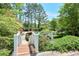 Inviting walkway leading to the community pool area, with lush greenery and mature trees for privacy at 2120 River Heights Se Walk, Marietta, GA 30067
