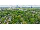 Overhead shot of a neighborhood with lush greenery and a skyline view in the distance at 2840 Alpine Rd, Atlanta, GA 30305