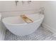 Elegant standalone soaking tub with a decorative patterned floor and chrome fixtures at 2840 Alpine Rd, Atlanta, GA 30305