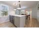 Bright kitchen with white cabinets, stone countertops, wine coolers and stainless steel pendant lights at 2840 Alpine Rd, Atlanta, GA 30305