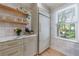 Kitchen detail showcasing custom cabinets, floating shelves, and a view from the window at 2840 Alpine Rd, Atlanta, GA 30305
